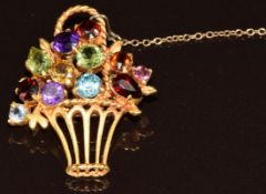 A 9ct gold brooch in the form of a bunch of flowers set with garnet, zircon, amethyst, peridot,