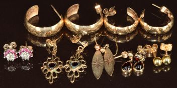 Seven pairs of 9ct gold earrings including ruby and diamond clusters, hoops, garnet, 11.7g