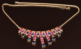 A 9ct gold necklace set with twenty three oval rubies totalling approximately 6.3ct, nineteen blue