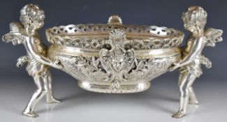 Silver plated centrepiece formed as a large oval bowl supported by two winged cherubs, length 52cm