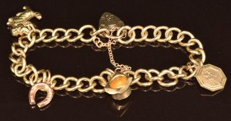 A 9ct gold charm bracelet with four 9ct gold charms including horseshoe, St Christopher, hat and