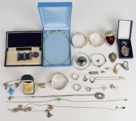 A collection of jewellery, some silver including chains and pendants, three bangles, a locket, ingot