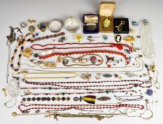 A collection of jewellery including two silver bangles, 9ct gold cross pendant, glass beads,