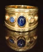 An 18ct gold ring set with two sapphire cabochons (one cabochon missing), 13g, size M