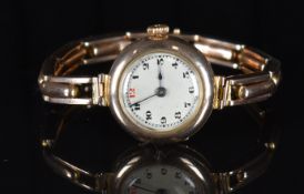 Edwardian 9ct gold ladies wristwatch with blued hands black Arabic numerals, silver dial and