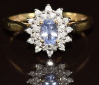 A 9k gold ring set with an oval cut tanzanite surrounded by diamonds, 2.4g, size Q