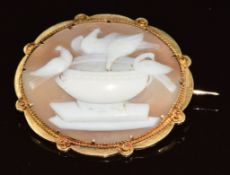 Victorian yellow metal brooch set with a cameo depicting four doves at a font, signed to back, 8.8g,