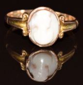 A 9ct rose gold ring set with a coral cameo, Chester 1917, in heart shaped antique box, 1.4g, size