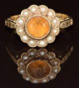 A 9ct gold ring set with a round cut citrine surrounded by seed pearls, 2.7g, size J