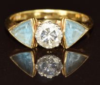 An 18ct gold ring set with a diamond of approximately 0.6ct and two trilliant cut topaz, 3g, size J