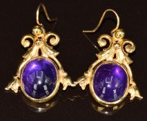 A pair of 9ct gold earrings each set with an amethyst cabochon, 5.1g