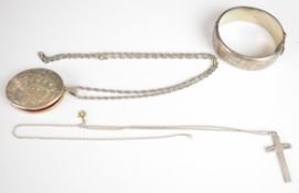 A silver bangle, large silver locket on silver chain and a silver cross pendant, Chester 1915, 81g