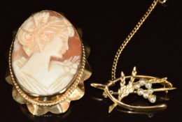 A 9ct gold brooch set with a cameo and a 9ct gold brooch in the form of a wishbone and heather by