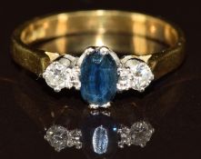 An 18ct gold ring set with an oval cut sapphire of approximately 0.4ct and diamonds, 2.7g, size J/K