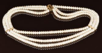 A three strand cultured pearl necklace with 14k gold clasp and spacers, 67.5g, 44cm