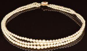 Three strand pearl necklace, the 9ct gold clasp set with a citrine and further pearls, 39g, 41cm