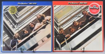 Two Beatles LPs. 1962-1966 on red vinyl and 1967-1970. Vinyl and covers appear Ex or better