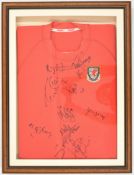Wales retro home shirt signed by eleven of the football team including Ian Rush, housed in box