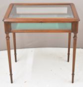19th / 20thC mahogany bijouterie / silver table with bevelled glass top, raised on reeded tapered