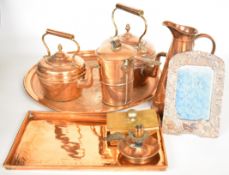 Copper ware including Eastern circular tray, kettles, Arts & Crafts chamberstick, pan with hinged