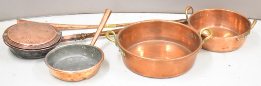 Two 19thC copper jam pans, frying pan and warmer, all with riveted handles, largest diameter 44cm