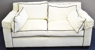 Ralph Lauren upholstered two cushion sofa in cream with black piping, probably in the Art Deco