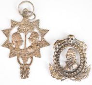Two silver pendants or fobs with images, possibly of Prince William V of Orange and his wife