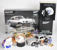 James Bond 007 related items comprising a Danbury Mint Aston Martin DB5 diecast model car with