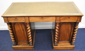 Victorian mahoagny leather inset desk with three drawers above twin cupboards, the doors having
