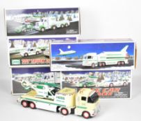 Six Hess plastic model toy trucks with battery operated lights and sounds, the majority in