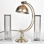 Pair of chrome and glass table lamps with ribbed circular glass tube uprights, possibly Timothy
