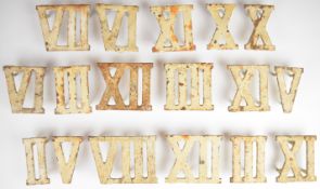 Seventeen painted cast iron Roman numerals, could be used as table place names or trivets, raised on