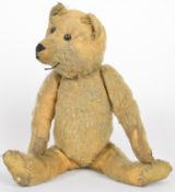 Early twentieth century straw filled Teddy bear with blonde mohair, stitched features, articulated