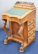 19thC walnut Davenport with fretwork gallery to the flip up lid, opening to reveal pen tray and