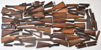 Over 60 shotgun and rifle stocks and forends including chequered semi-pistol and straight hand grips