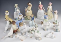 Approximately twenty Nao / Lladro figures including jesters, musicians, girl with doves etc, tallest