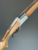 Lincoln 12 bore folding over and under shotgun with engraved scenes of dogs to the action, chequered