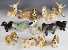 Twelve Szeiler figures and a Beswick elephant, items include moneyboxes and a figural bloodhound