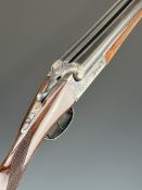 LIG 12 bore side by side shotgun with engraved locks, underside, thumb lever and fences, chequered