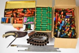 Over five hundred 12 bore shotgun cartridges together with a leather cartridge belt, cleaning rods