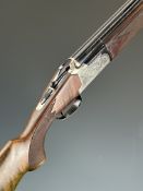 Lanber 12 bore over and under shotgun with engraved locks, underside, trigger guard and thumb lever,