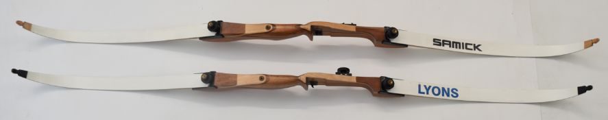 Two archery recurve bows both with laminated wooden handles, one with Lyons InterNature and one with