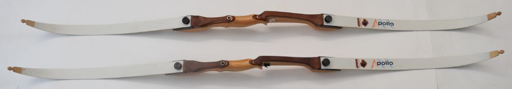 Two archery recurve bows both with laminated wooden handles and Apollo Black Sheep limbs.