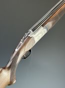 White Diamond 12 bore over and under ejector shotgun with named and engraved action and underside,