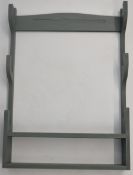 Wooden wall mounted gun rack to hold three shotguns or rifles and a small display of cartridges or