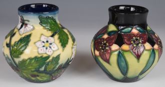 Two Moorcroft vases decorated in the Trillium and Fruit Garden patterns, dated 99 and 2000, H9cm
