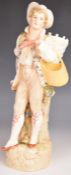 KPM porcelain figure of a grape harvester / gatherer with baskets, H36cm