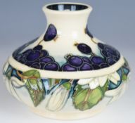 Moorcroft squat pedestal vase decorated in the Juneberry pattern, dated 2000 to base, H12cm