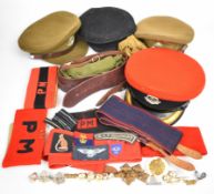 Collection of military hats, belts and webbing and badges, most Royal Military Police including