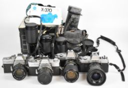 Four Minolta 35mm SLR cameras comprising X-300, X-370, SR-T 303 and SR-T 101b, with Minolta MC